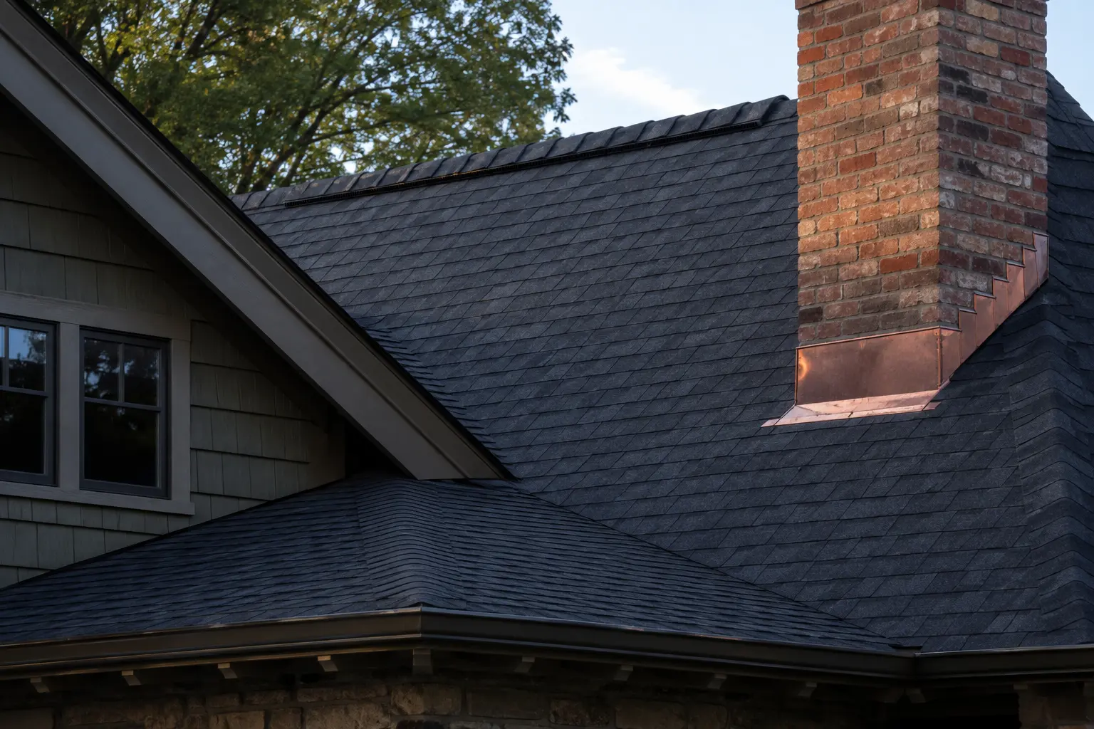 Completed charcoal roof and precise chimney flashing on a Knoxville home